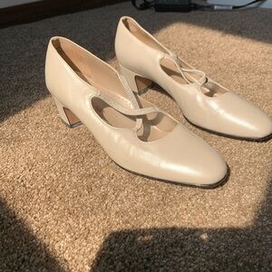 All leather, pearl in color, size 7.5. One scuff mark that can be easily removed